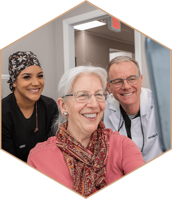 Dr. Brian Marino and a team member smiling with a patient at Whitehouse Station Center for Dentistry in Whitehouse Station, New Jersey